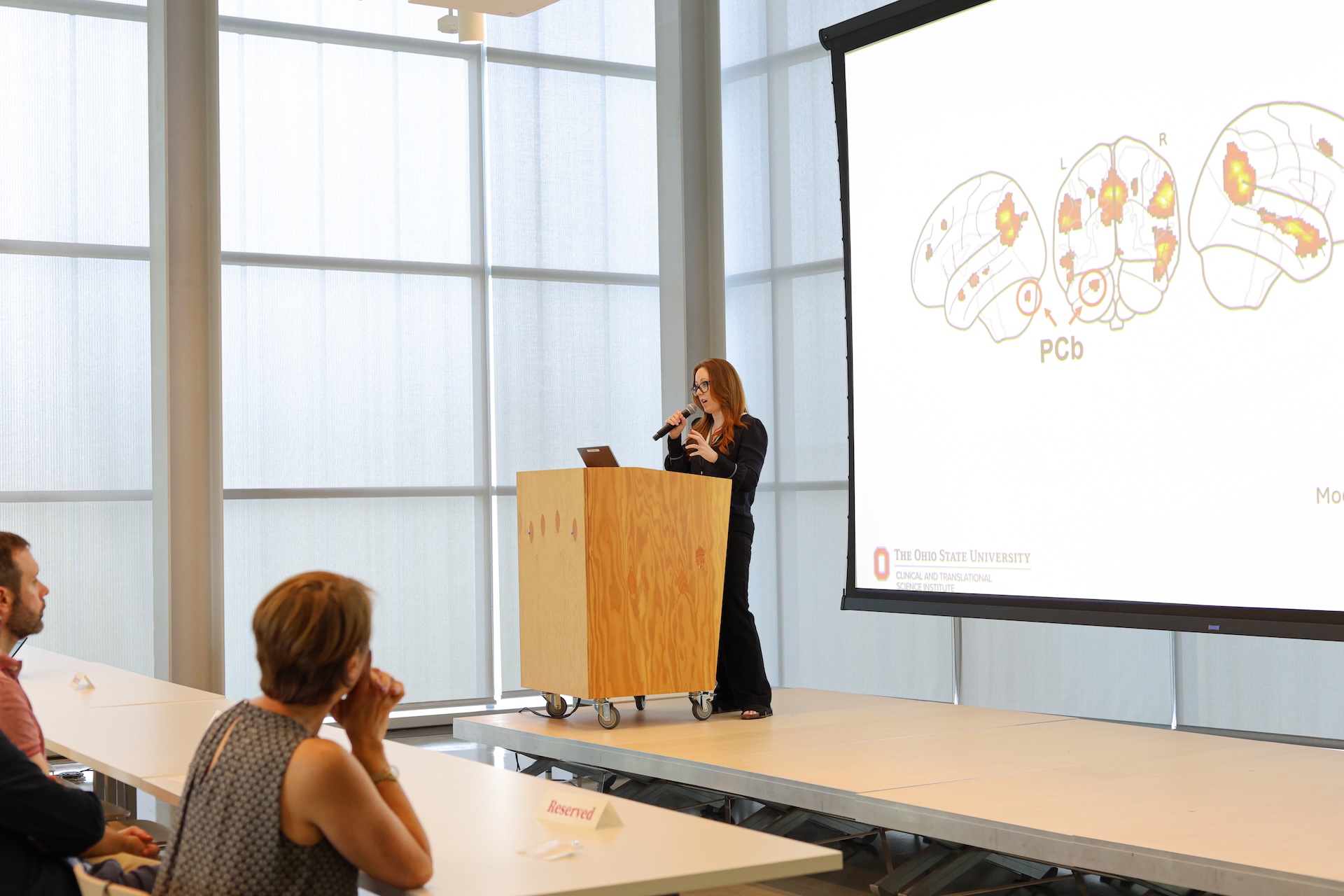 Aubrey Moe addressing attendees during the research showcase