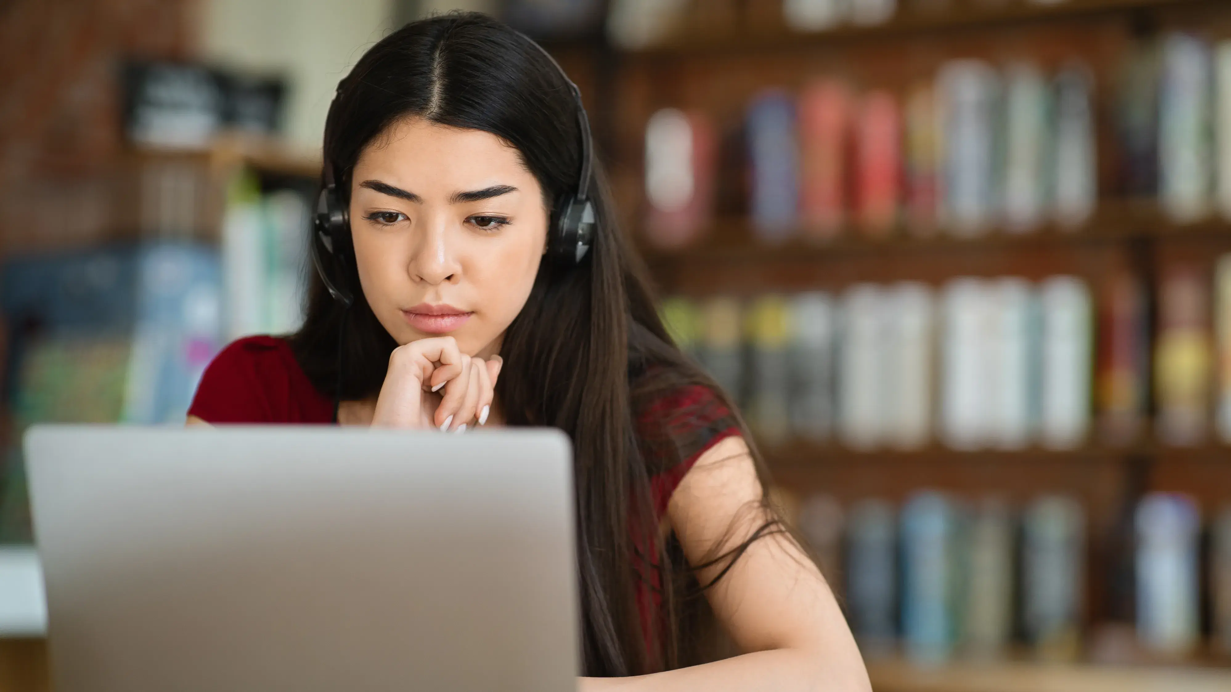 Woman using laptop in library