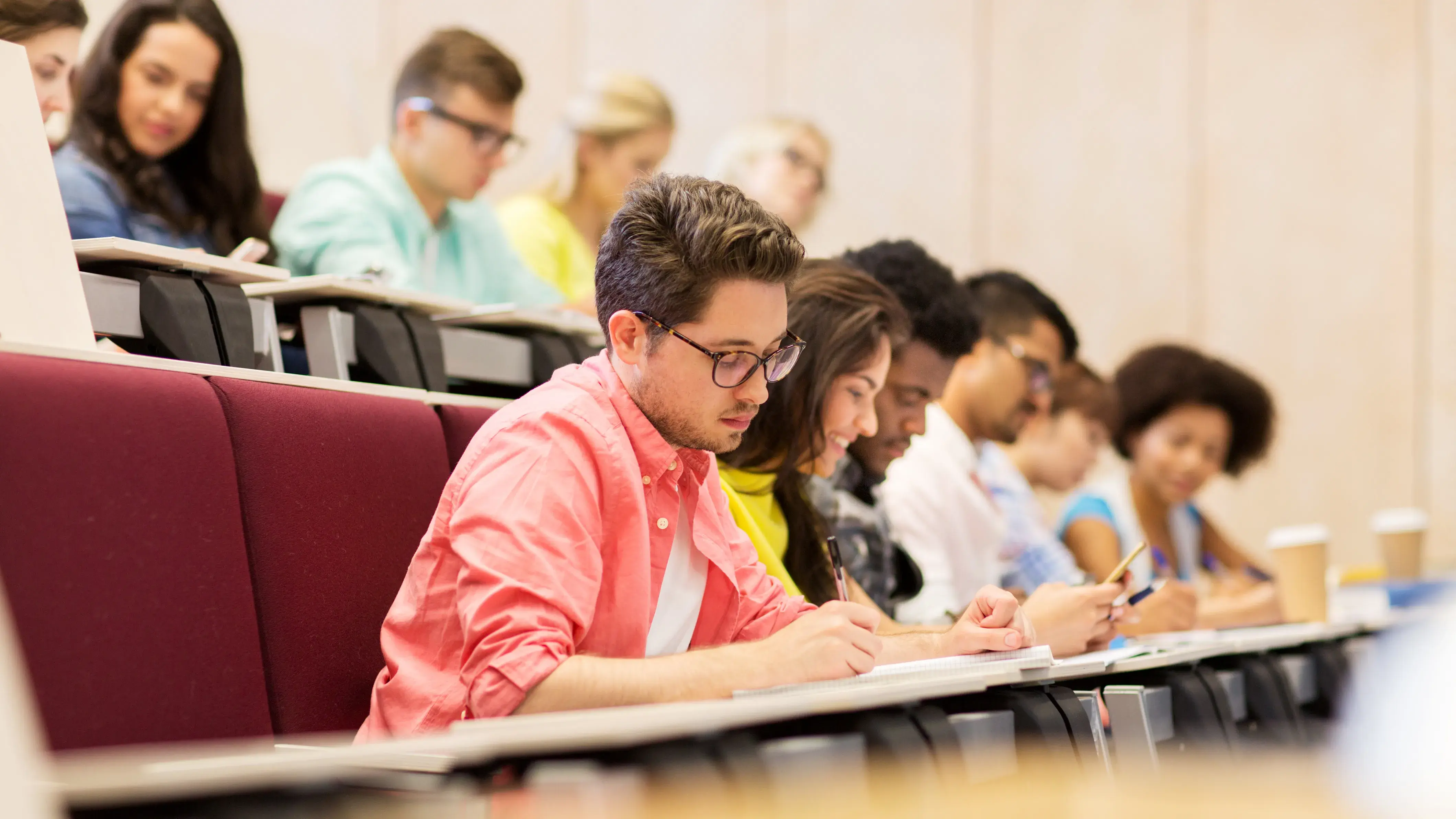group of students with notebooks in lecture hall