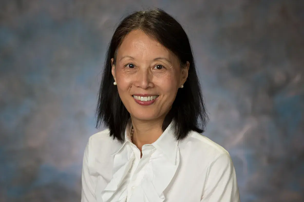 portrait of Jingzhen “Ginger” Yang in a white shirt