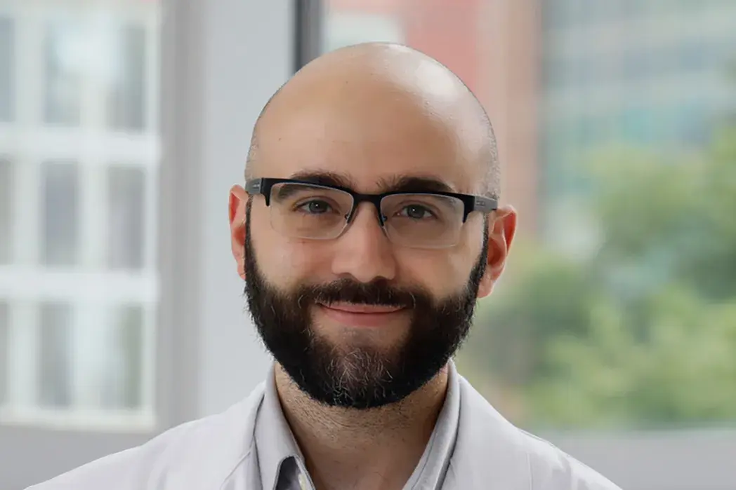 portrait of Mohamed Ridha wearing a white shirt and glasses