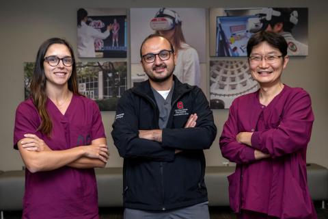 Rebecca Leme Gallardo, Moataz Abouammo and Je Beom Hong smiling and posing together wearing Ohio State branded scrubs.